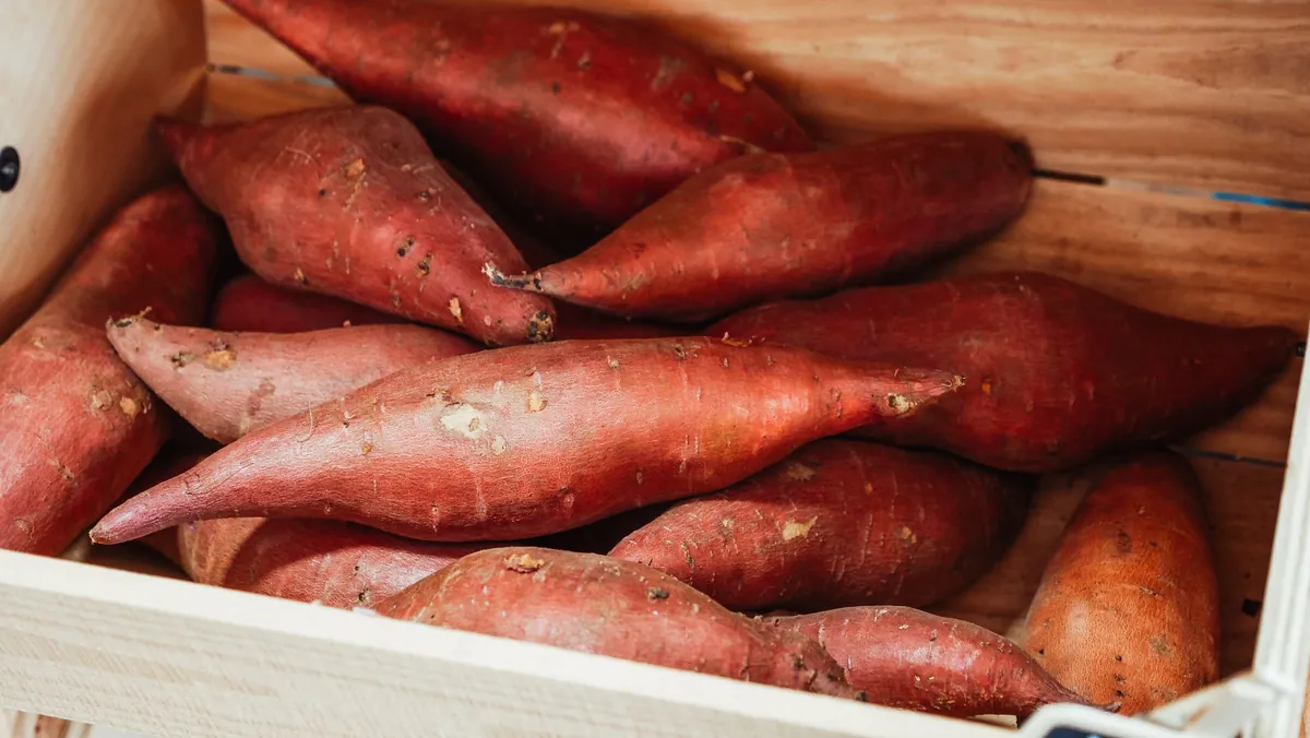 Sweet potatoes in a wooden crate